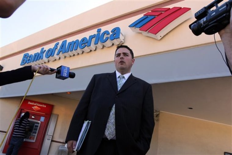 Todd Allen, attorney for Warren and Maureen Nyerges, speaks to the media outside a Bank of America branch on Davis Boulevard, in Naples, Fla., while deputies meet with the bank manager inside. Bank of America tried to foreclose on the Nyerges' fully-paid, Golden Gate Estates home last year, starting a legal battle with the couple, who had paid cash for the home in 2009. 